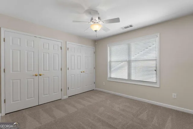 a view of an empty room with a fan