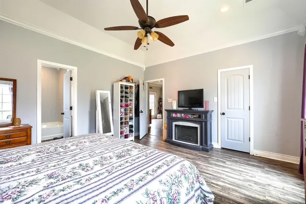 a bedroom with furniture a bed and a flat screen tv