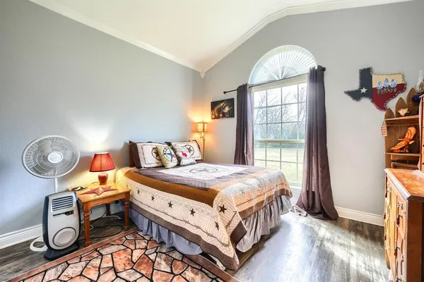 a bedroom with bed and a window