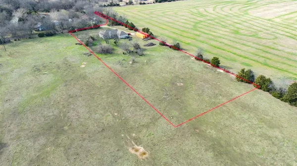 a view of a water pond with green field
