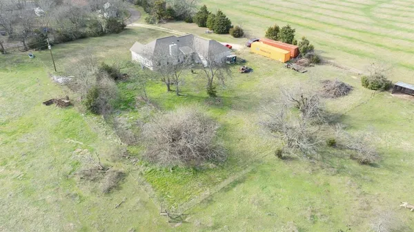 a backyard of a house with lots of green space and lake view