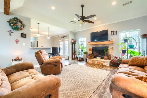 a living room with furniture a flat screen tv and a fireplace