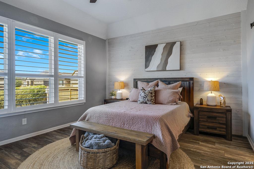 12805 Big Tank Ranch San Antonio, TX 78245 - Photo 17 of 35 a bedroom with a bed and wooden floor