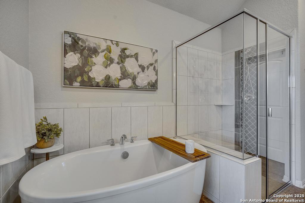 12805 Big Tank Ranch San Antonio, TX 78245 - Photo 19 of 35 a bathroom with a tub and a shower