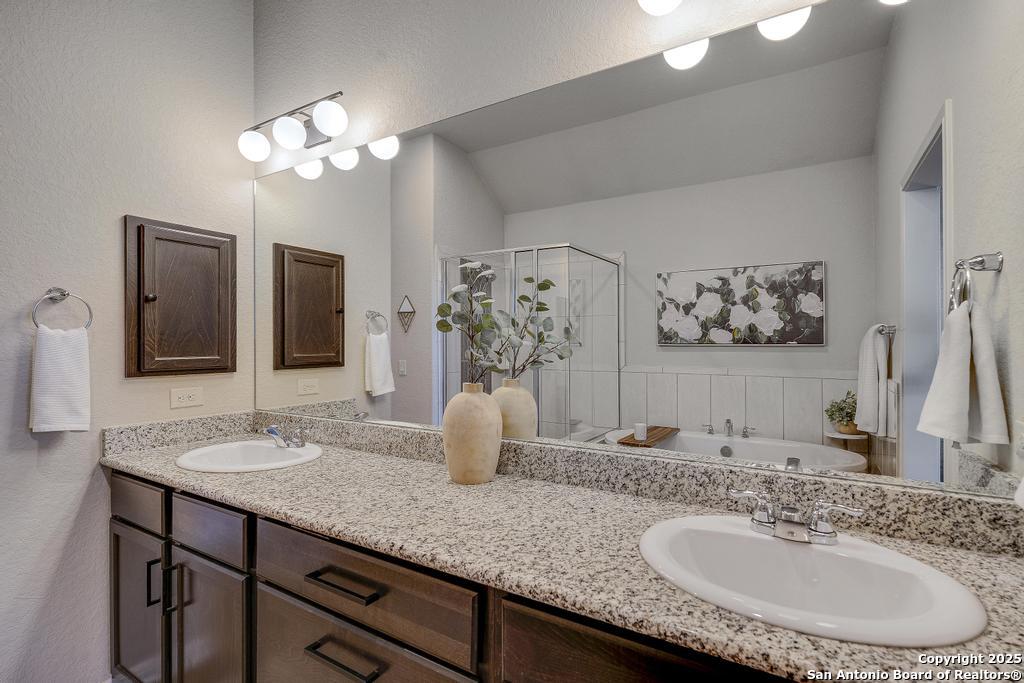 12805 Big Tank Ranch San Antonio, TX 78245 - Photo 20 of 35 a bathroom with a granite countertop double vanity sink and a mirror