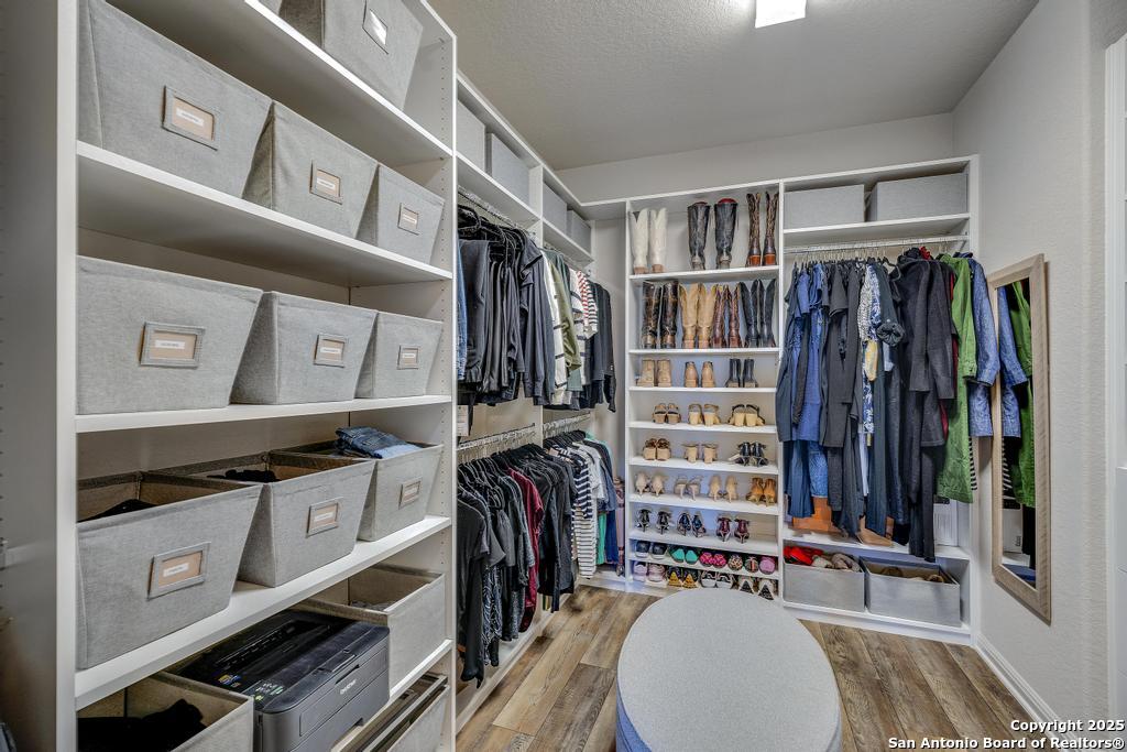 12805 Big Tank Ranch San Antonio, TX 78245 - Photo 21 of 35 a view of walk in closet with clothes and shoes