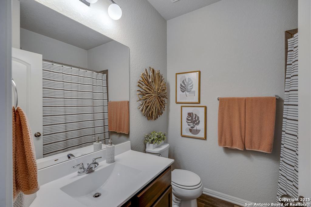 12805 Big Tank Ranch San Antonio, TX 78245 - Photo 24 of 35 a bathroom with a sink and a toilet