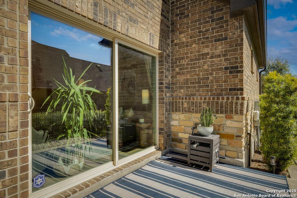 12805 Big Tank Ranch San Antonio, TX 78245 - Photo 4 of 35 a view of a door and chair in the balcony with glass door