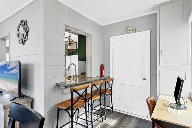 a view of a workspace with furniture and wooden floor