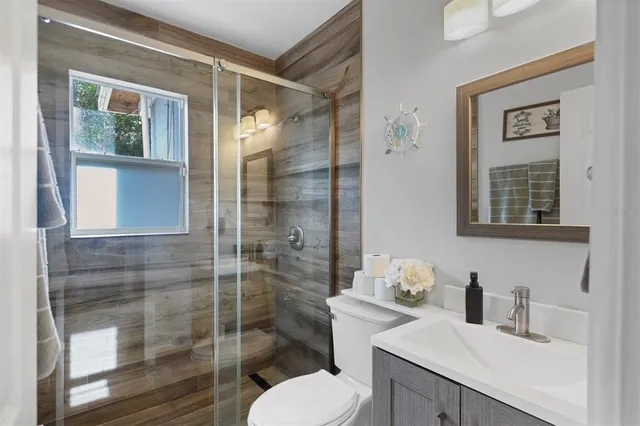 a bathroom with a sink toilet and shower