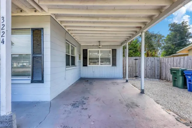 a view of backyard with small cabin and wooden fence