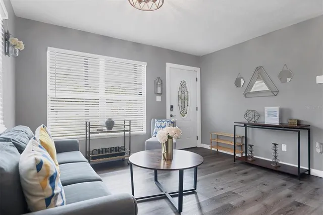 a living room with furniture and wooden floor