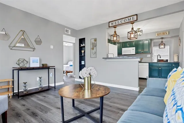 a view of a kitchen with kitchen island a dining table and chairs