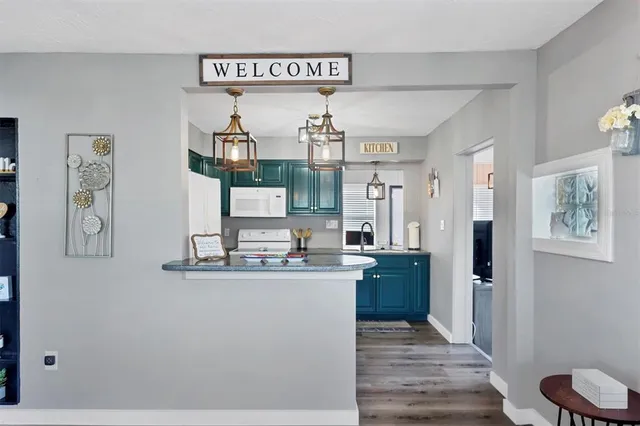 a kitchen with kitchen island stainless steel appliances a sink and refrigerator