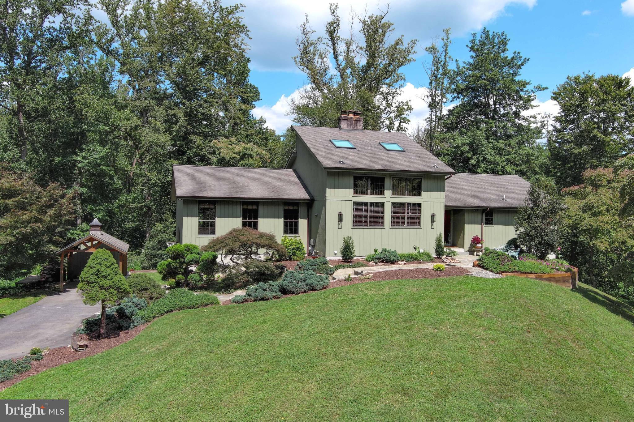 2520 Colonial Road Accokeek, MD 20607 - Photo 1 of 74 a front view of a house with a garden and trees