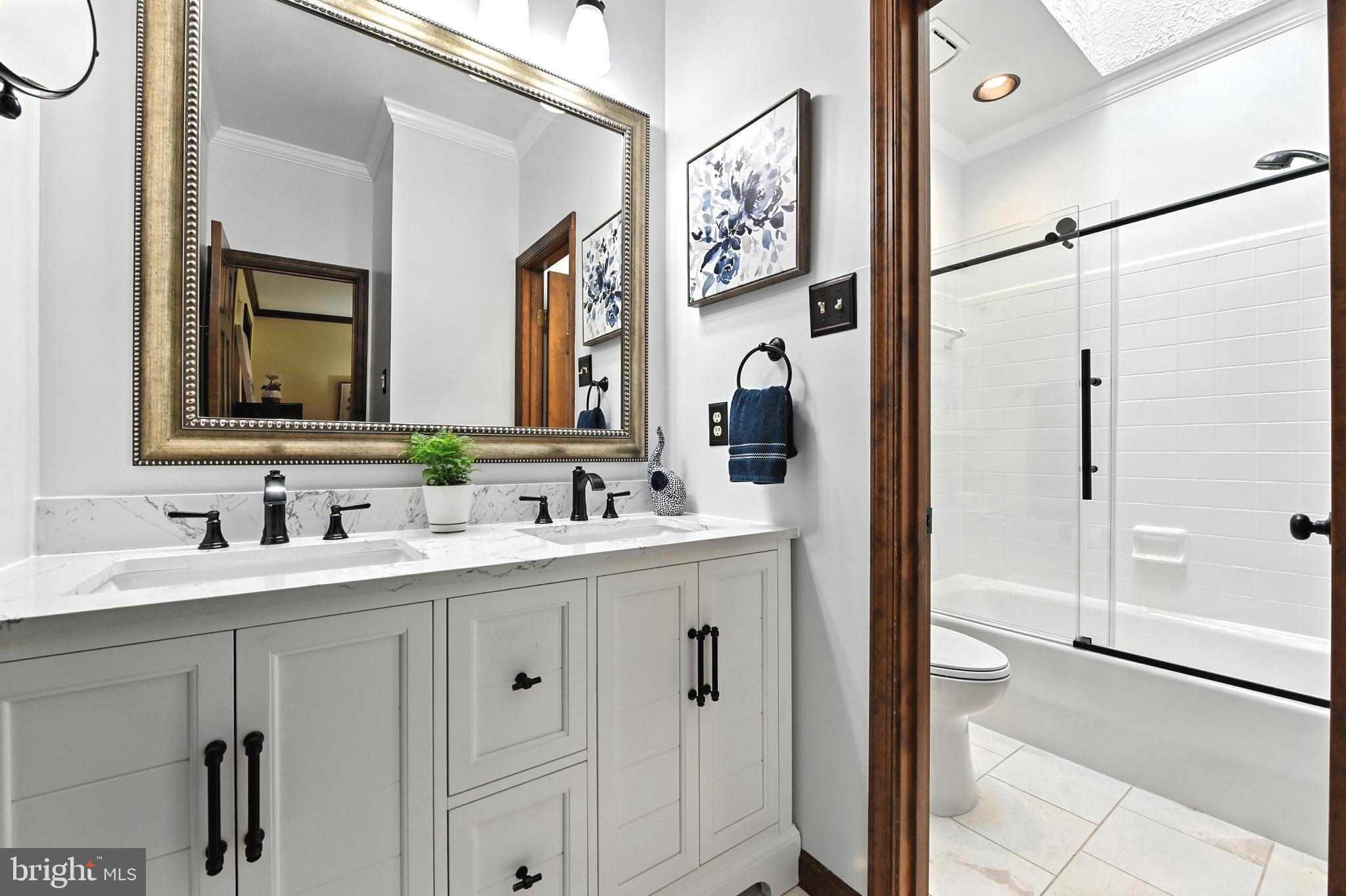 2520 Colonial Road Accokeek, MD 20607 - Photo 21 of 74 a bathroom with a double vanity sink mirror and shower