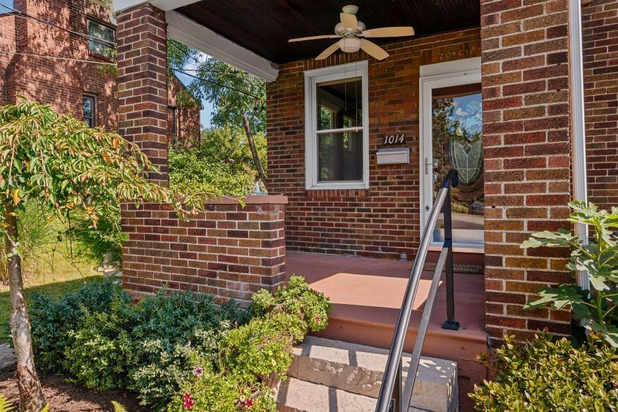 1014 S Road Pittsburgh, PA 15209 - Photo 3 of 26 a brick building with a bench and potted plants