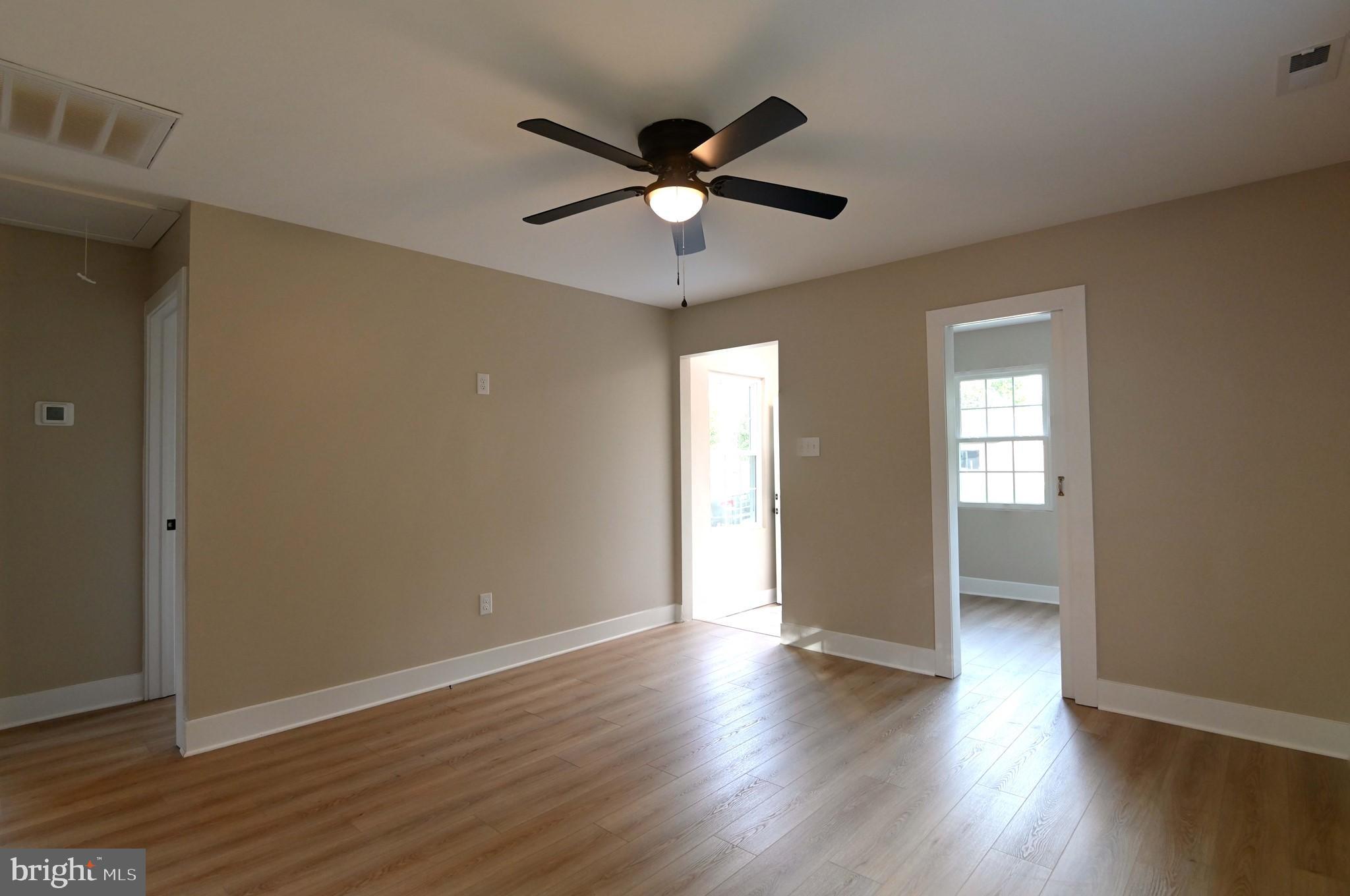 1616 Beech Road St. Leonard, MD 20685 - Photo 27 of 40 a view of an empty room with wooden floor and a window