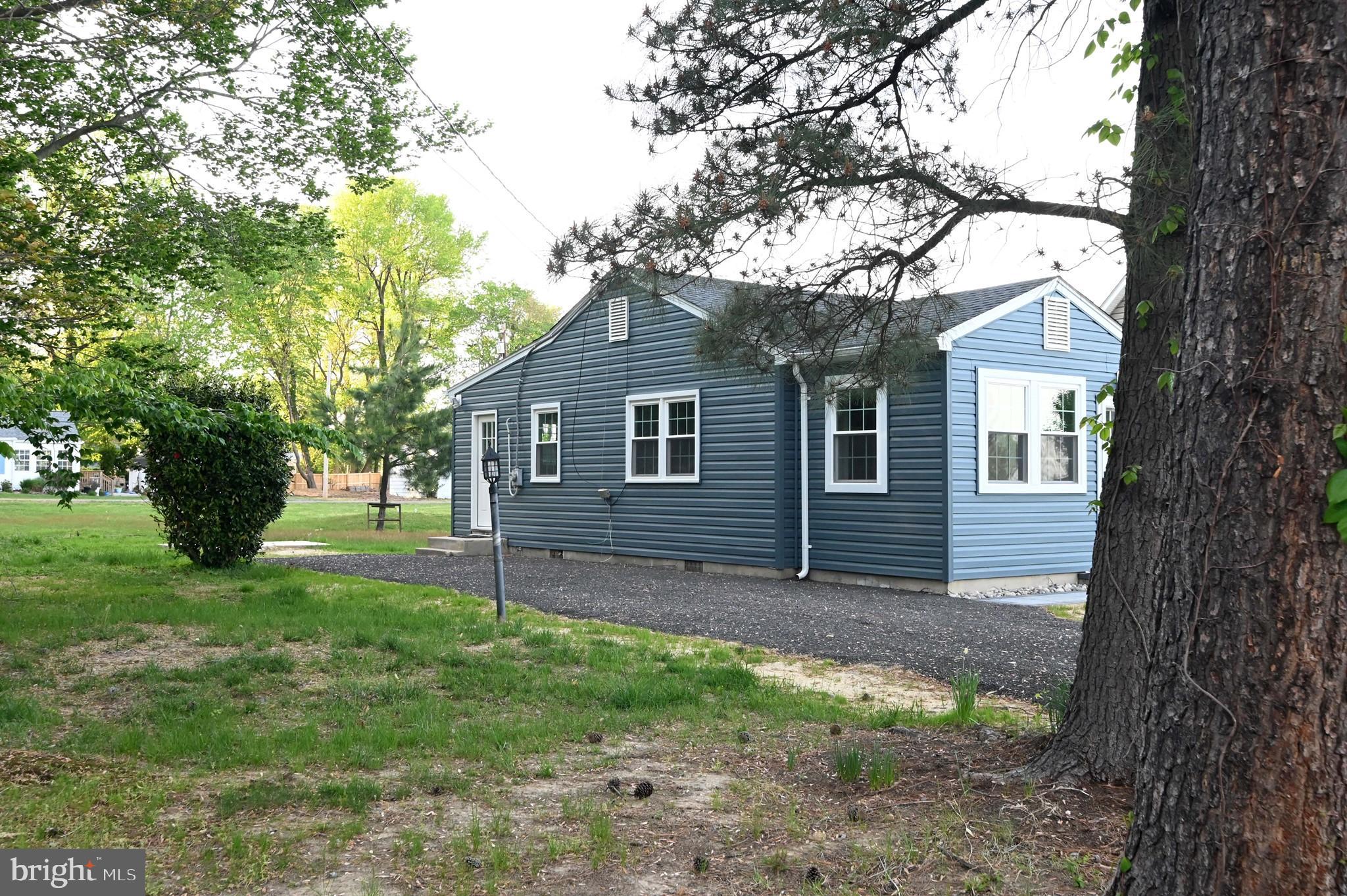1616 Beech Road St. Leonard, MD 20685 - Photo 38 of 40 a view of a yard in front of a house with large tree
