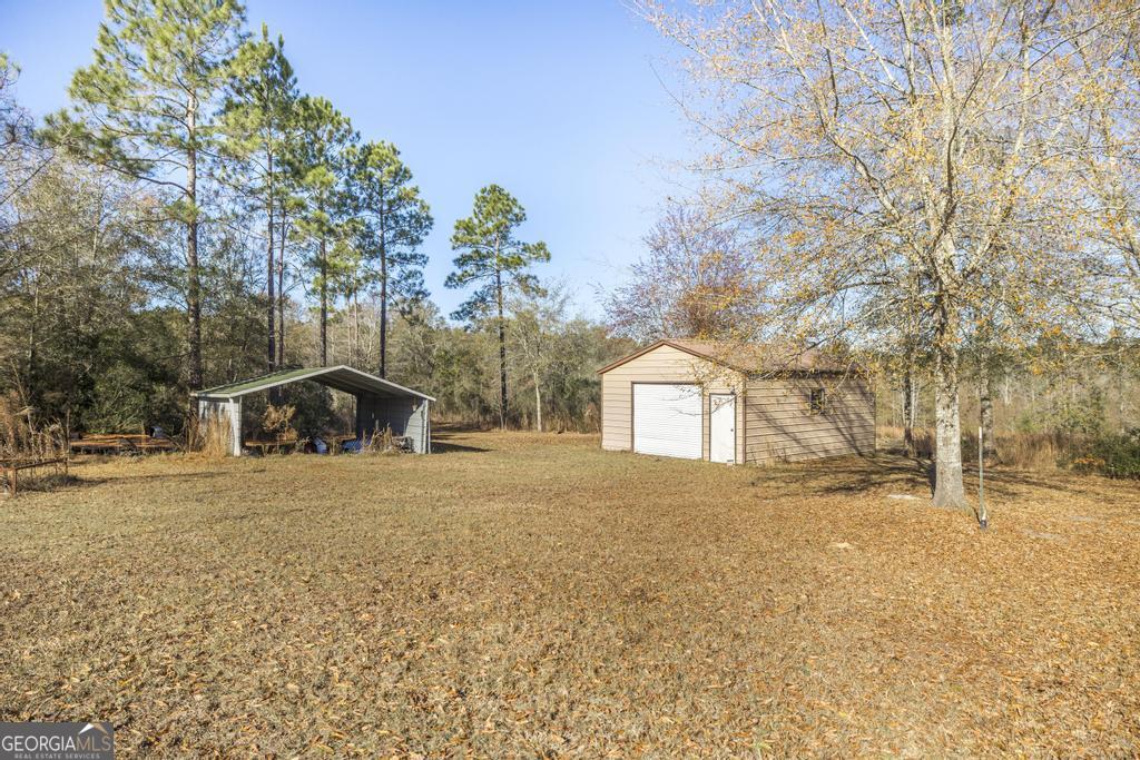 4065 Gordon Road Abbeville, GA 31001 - Photo 41 of 48 a front view of a house with a yard covered in snow