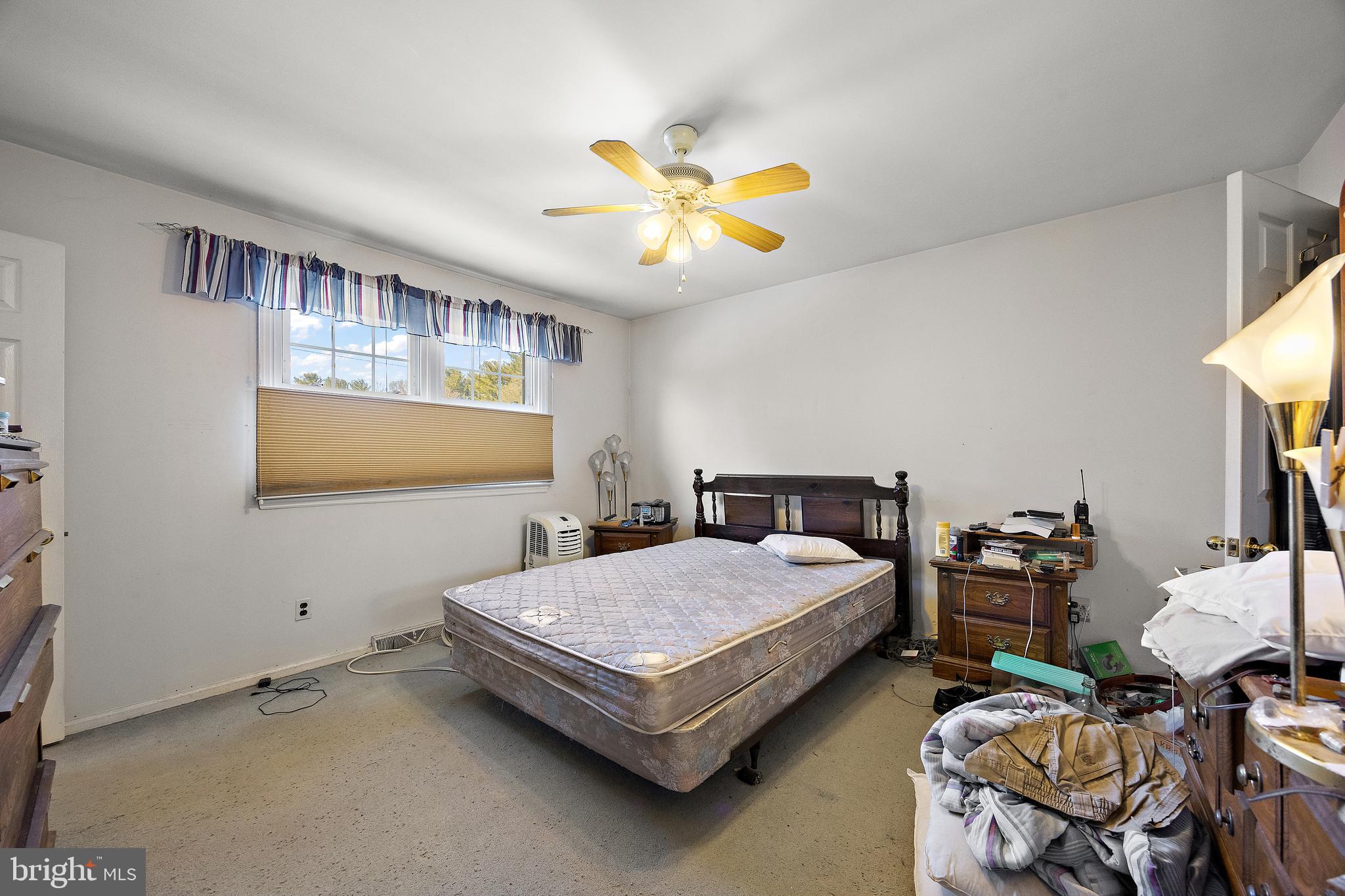 506 Cambridge Drive Newark, DE 19711 - Photo 26 of 38 a bedroom with a bed and a chandelier
