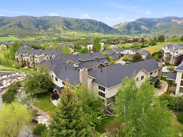 3634 North Huntsman Path, Unit C203 Eden, UT 84310 - Photo 25 of 27 Expansive residential community featuring multiple buildings with dark shingle roofs, light-toned siding, and stone chimney accents