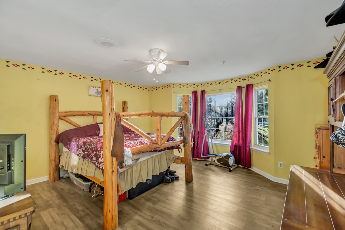 10722 Chestnut Ridge Road Lynchburg, TN 37352 - Photo 14 of 38 a bedroom with bed and a chandelier