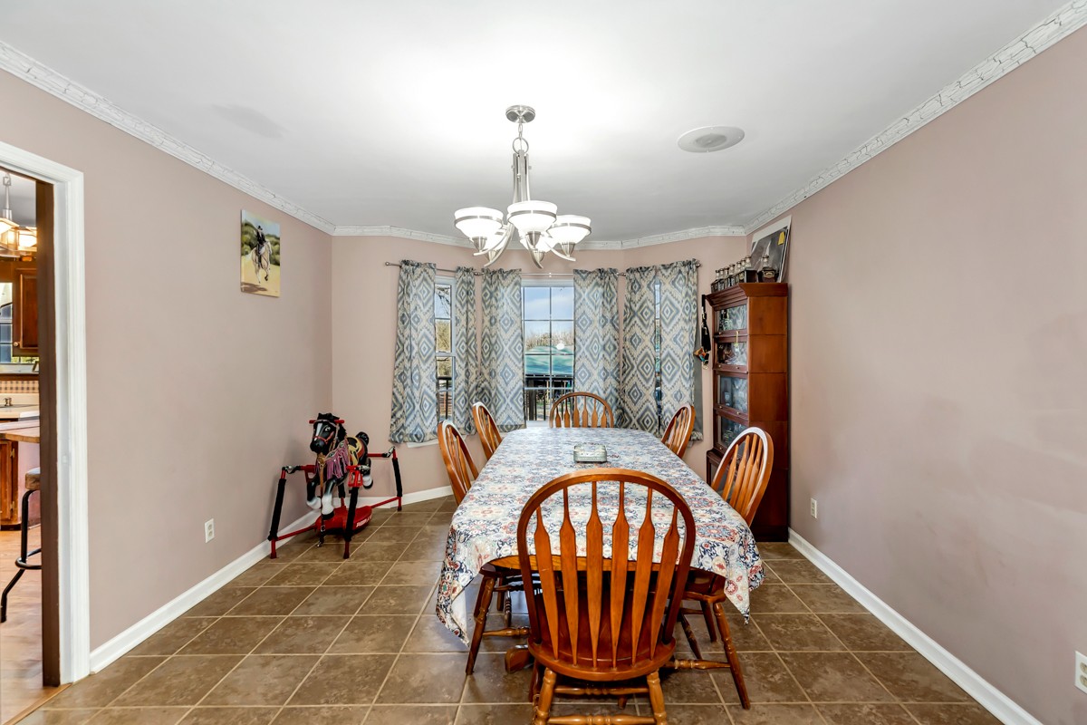 10722 Chestnut Ridge Road Lynchburg, TN 37352 - Photo 8 of 38 a view of a dining room with furniture and chandelier