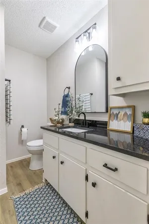 a bathroom with a double vanity sink and a toilet