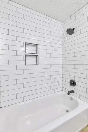 a bathroom with a bathtub and a shower