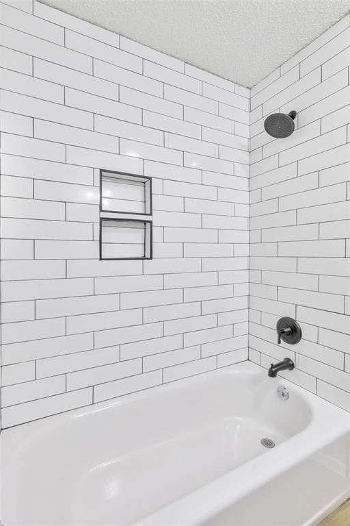 902 Turner Lane Tuscola, TX 79562 - Photo 17 of 22 a bathroom with a bathtub and a shower