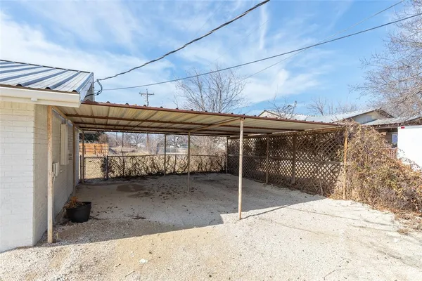 a view of a house with a wooden fence