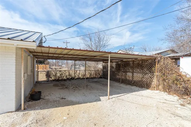 a view of a house with a wooden fence