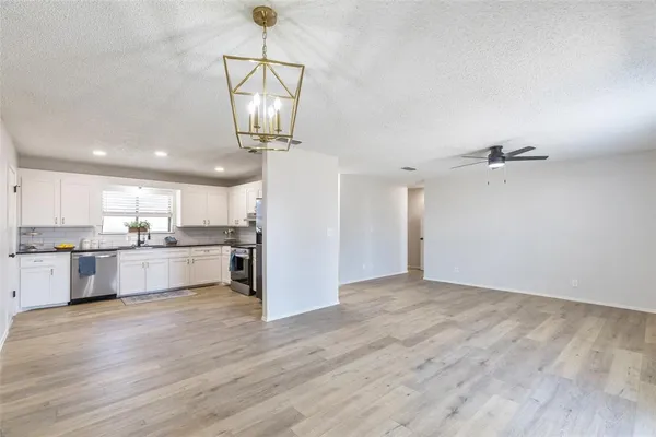 a view of a kitchen with a sink and cabinet
