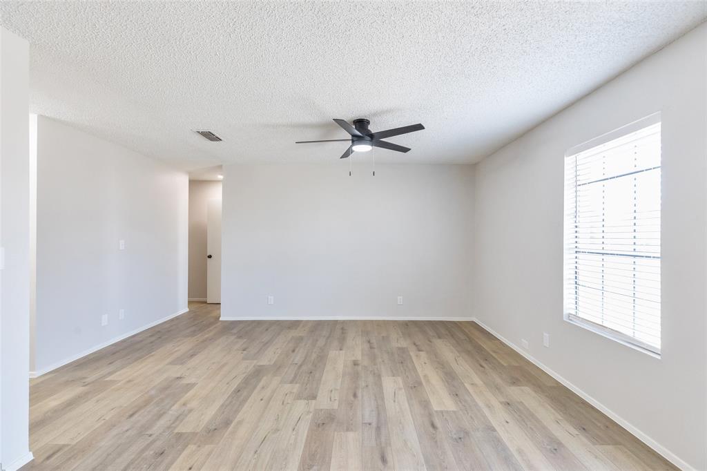 902 Turner Lane Tuscola, TX 79562 - Photo 6 of 22 wooden floor in an empty room with a window