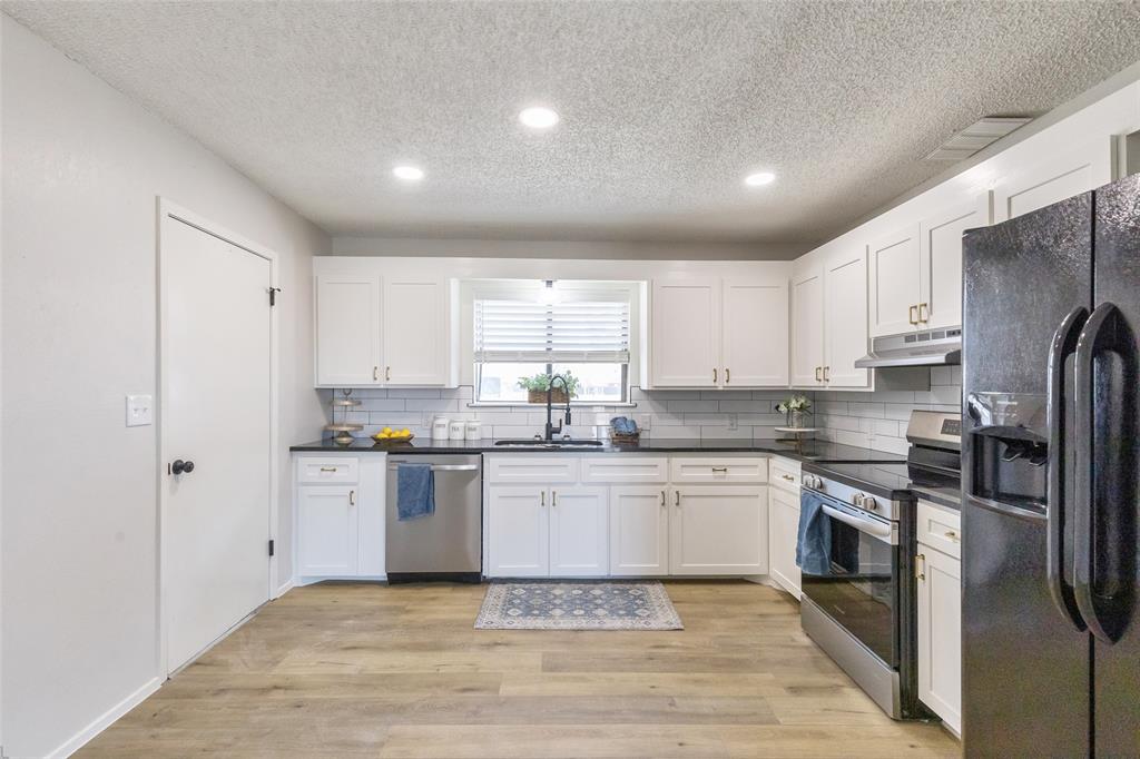 902 Turner Lane Tuscola, TX 79562 - Photo 8 of 22 a kitchen with stainless steel appliances granite countertop a stove a sink and a refrigerator