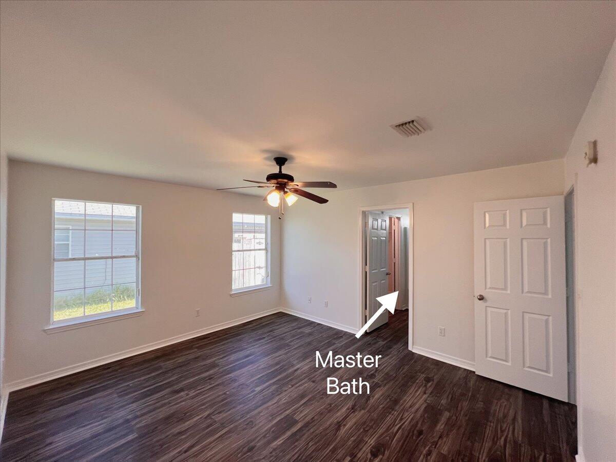 1782 Old Ranch Road Fort Walton Beach, FL 32547 - Photo 29 of 45 a view of an empty room with window and wooden floor