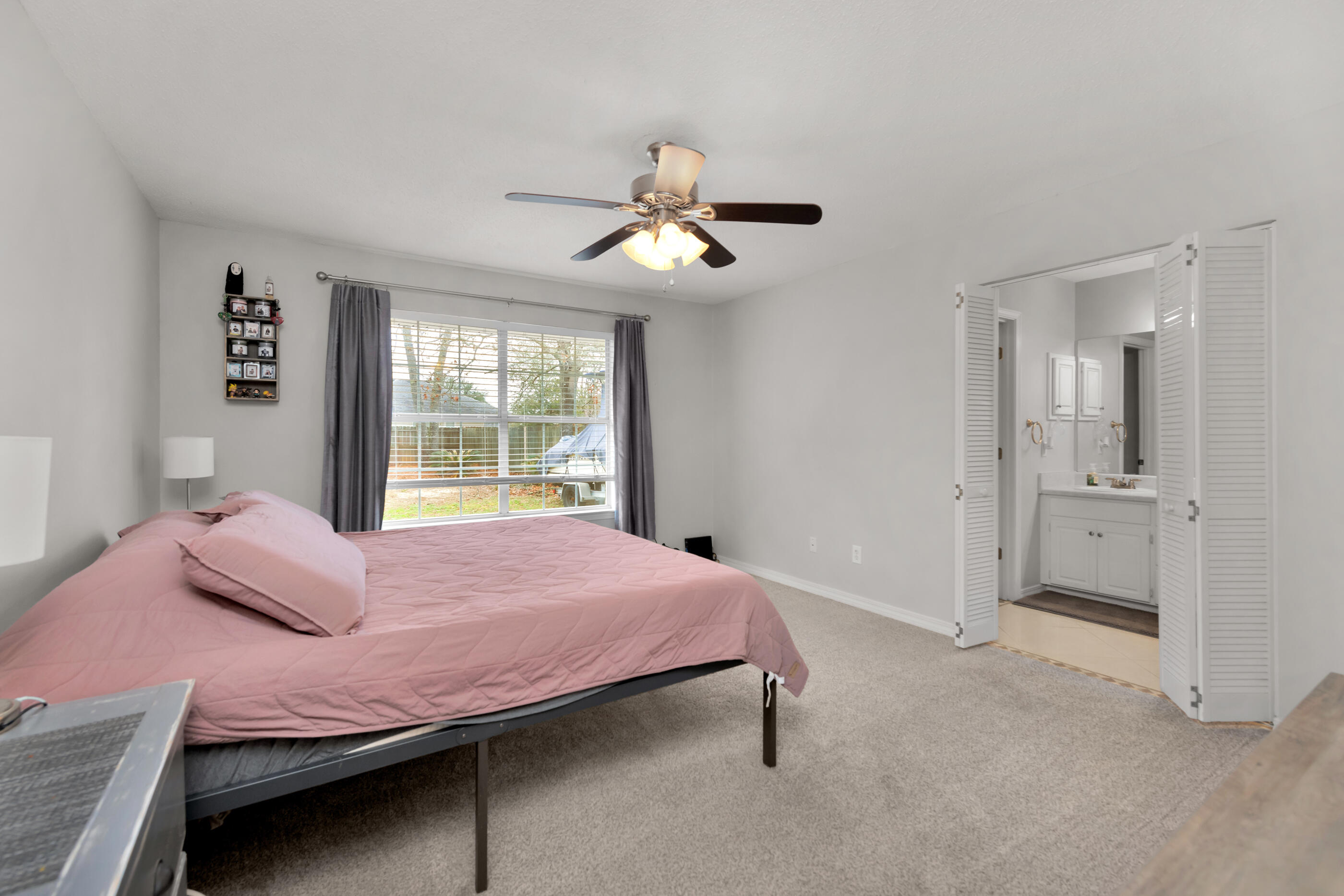 2831 Atoka Trail Crestview, FL 32539 - Photo 13 of 27 a bedroom with a bed and a chandelier