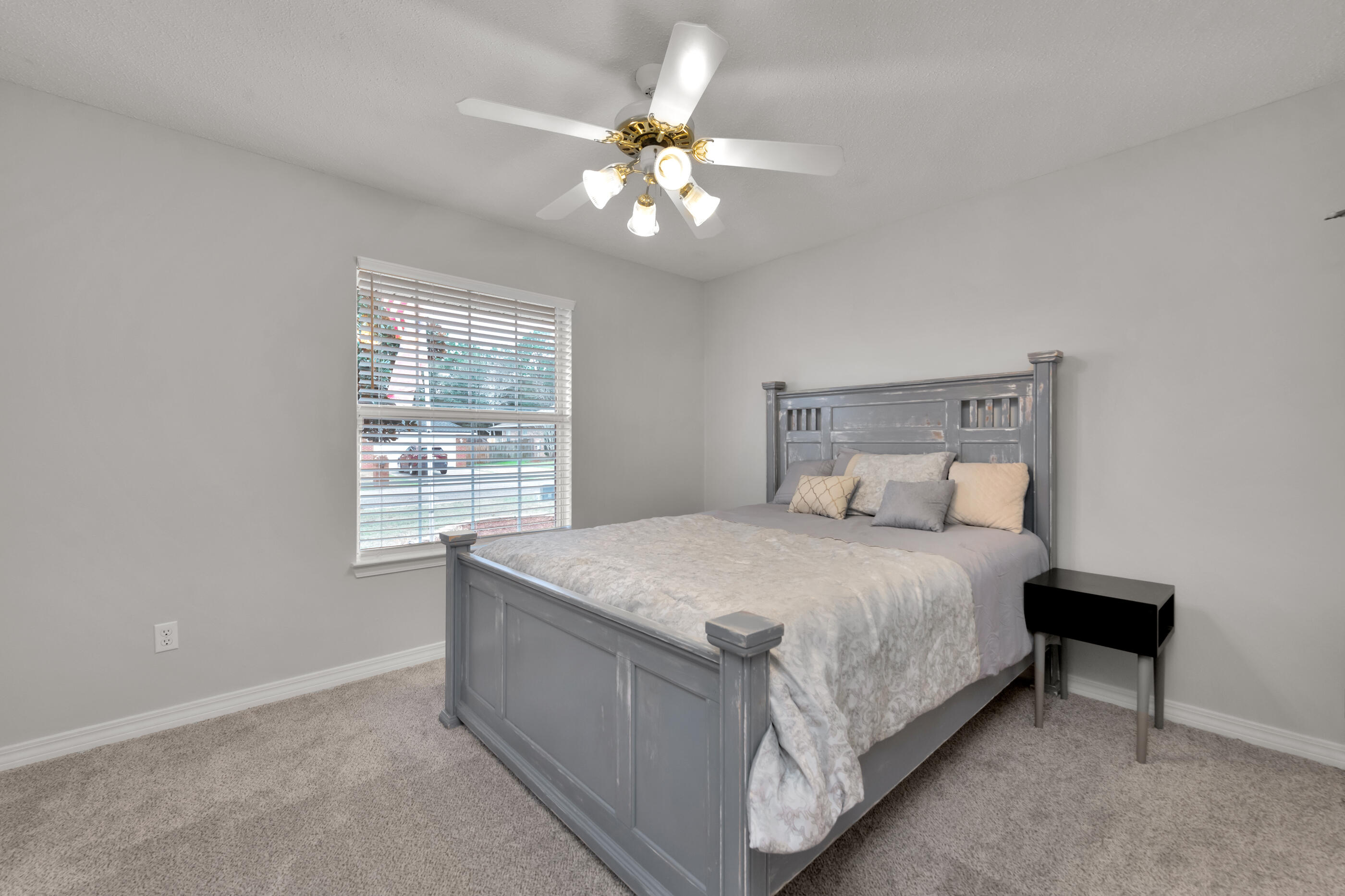 2831 Atoka Trail Crestview, FL 32539 - Photo 20 of 27 a bedroom with a bed and a chandelier