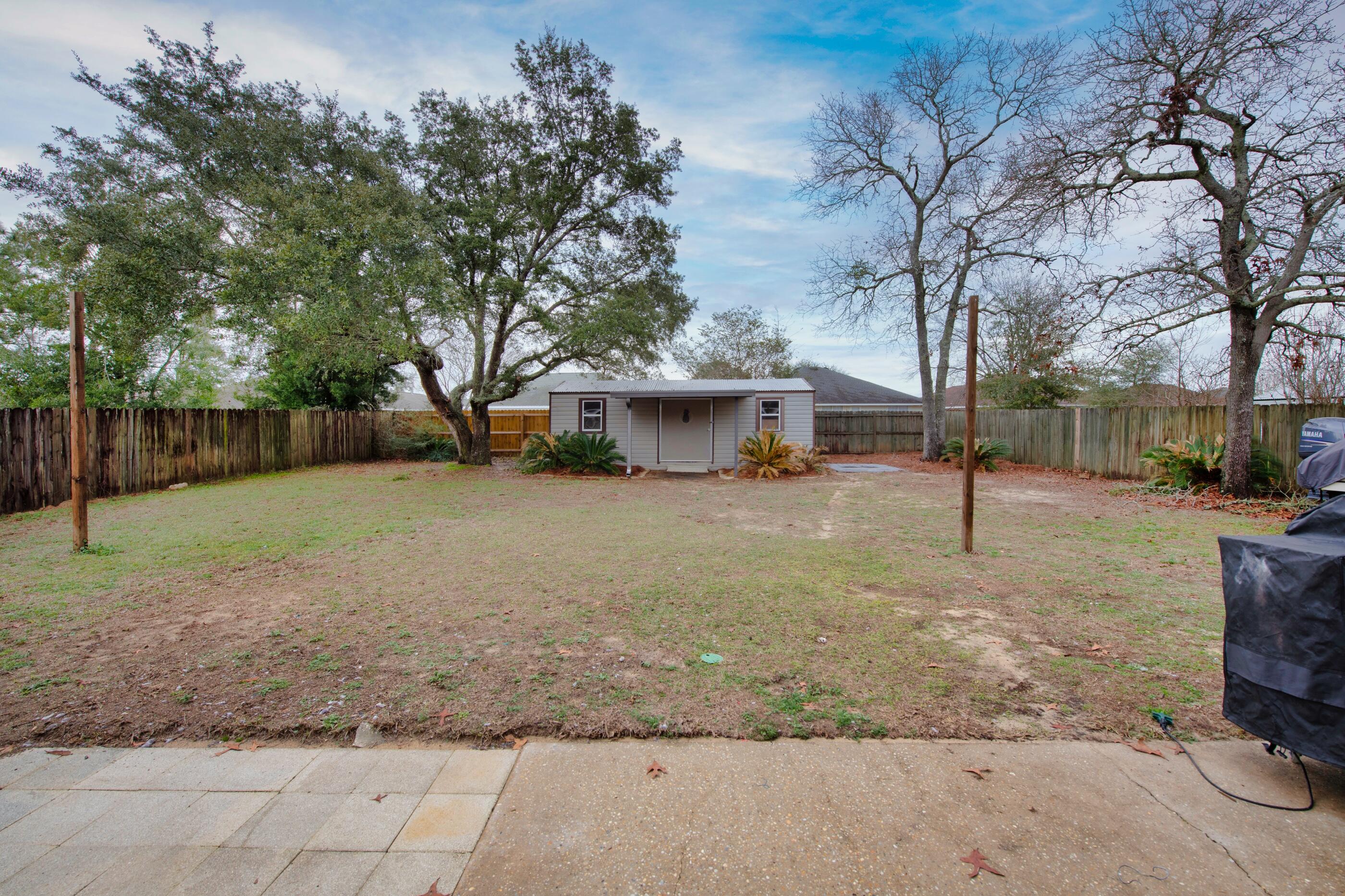 2831 Atoka Trail Crestview, FL 32539 - Photo 23 of 27 a view of a yard with a house and a tree