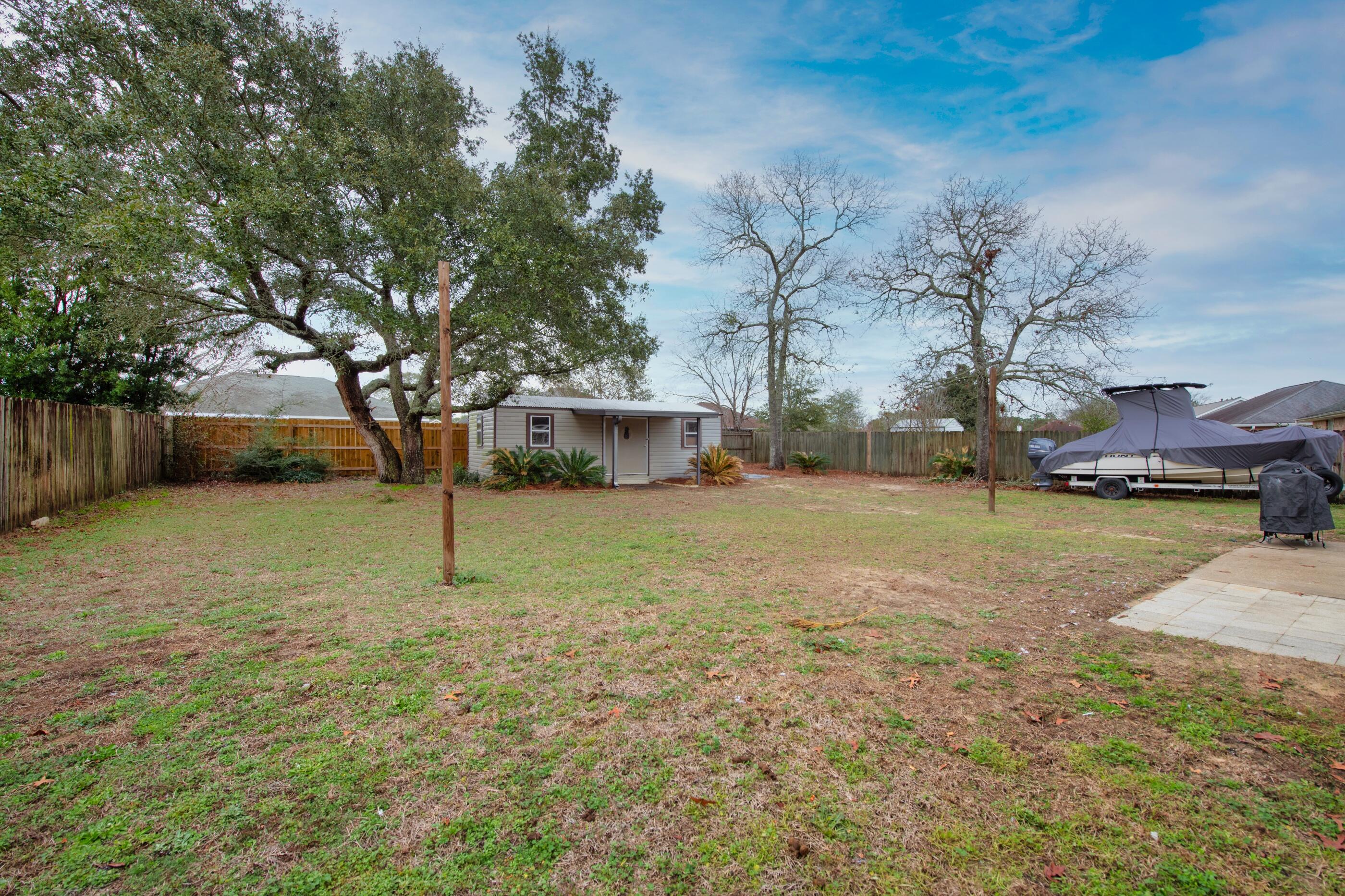2831 Atoka Trail Crestview, FL 32539 - Photo 24 of 27 a view of a yard with a tree