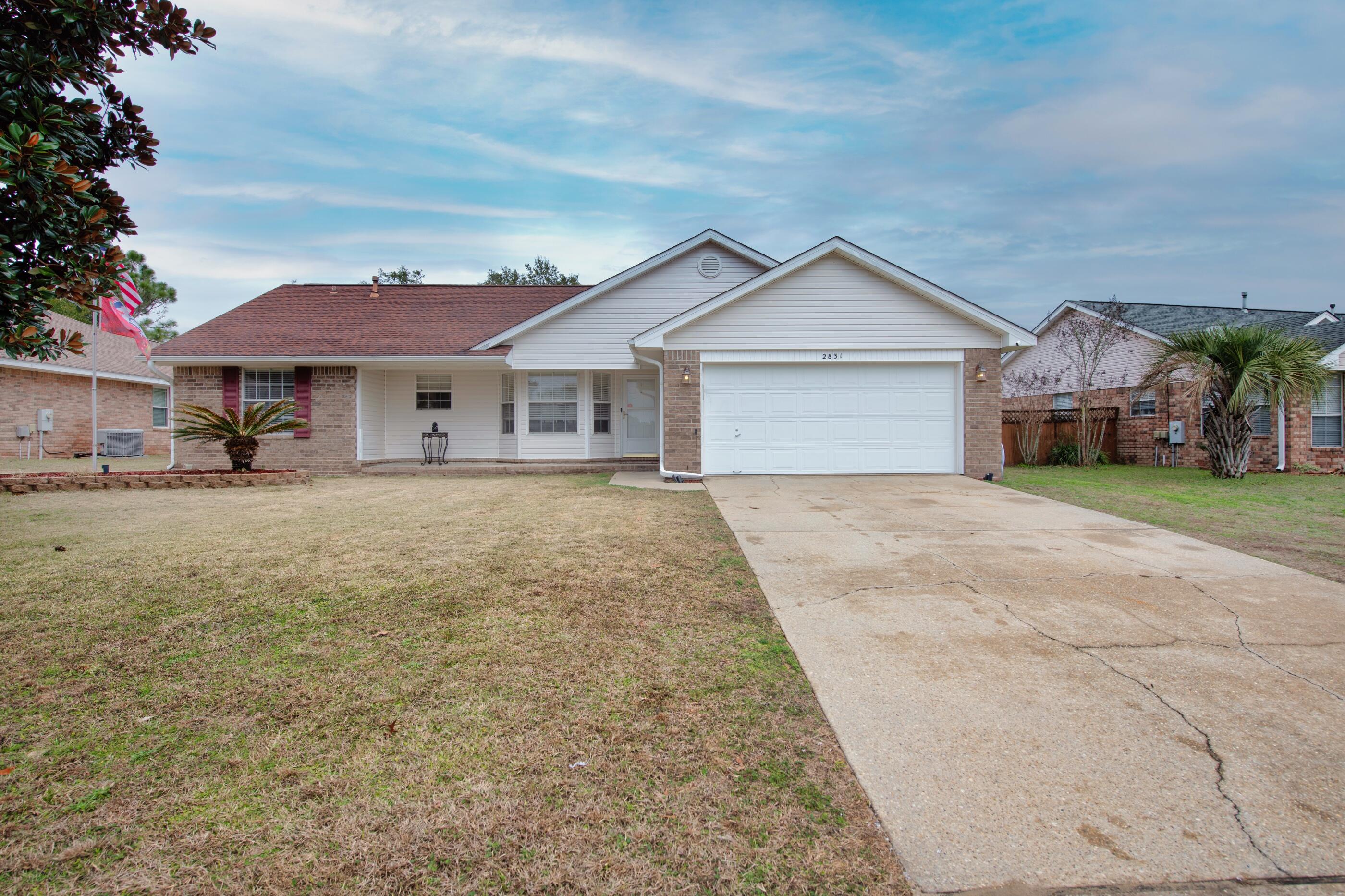 2831 Atoka Trail Crestview, FL 32539 - Photo 3 of 27 a view of a house with a yard and large trees