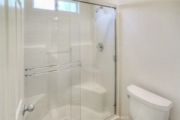 a bathroom with a shower and toilet