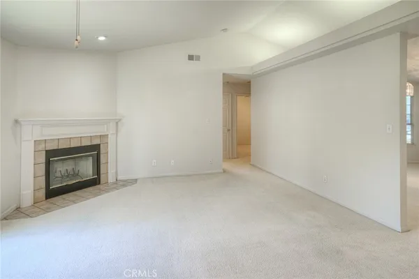 a view of an empty room with a fireplace