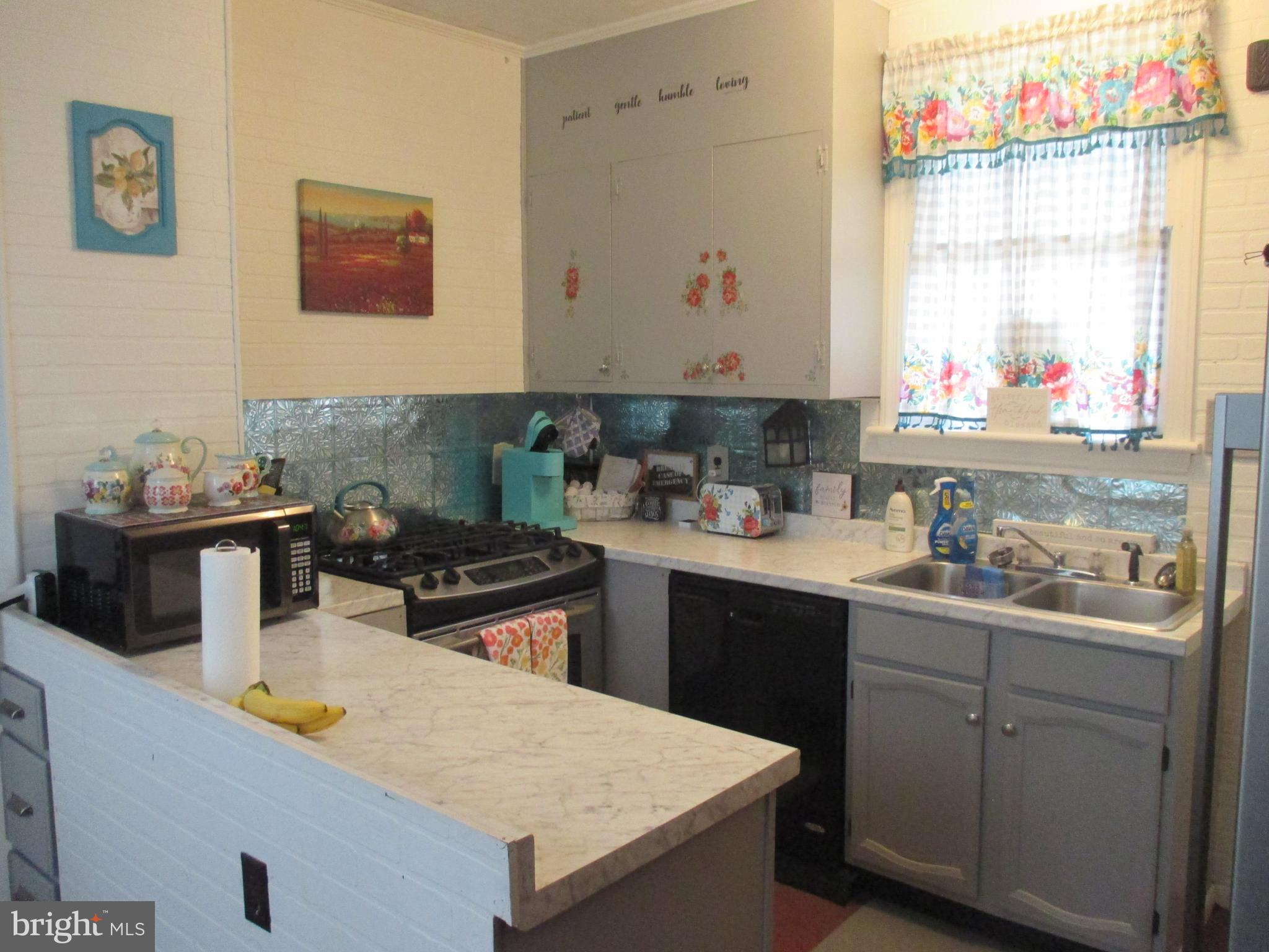 333 Pratt Street Luke, MD 21540 - Photo 3 of 42 a kitchen with a sink a stove and cabinets