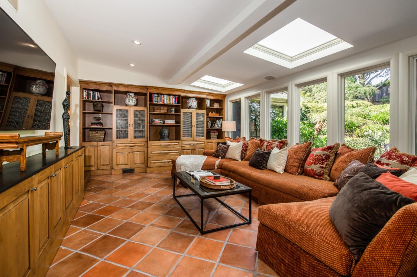 835 Longview Road Hillsborough, CA 94010 - Photo 14 of 31 a living room with furniture a flat screen tv and floor to ceiling window