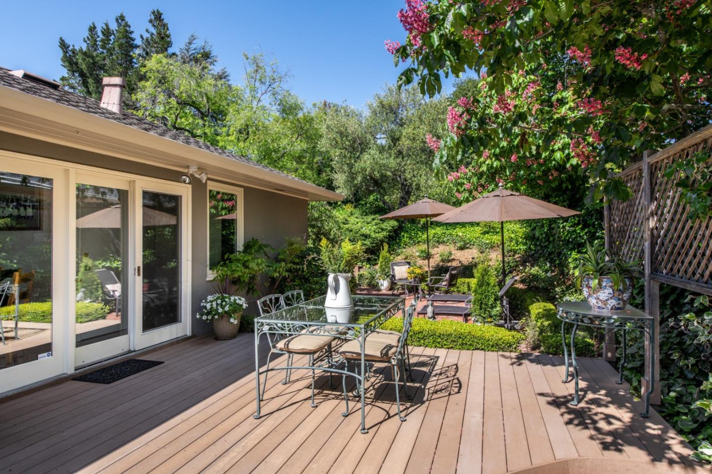 835 Longview Road Hillsborough, CA 94010 - Photo 27 of 31 a view of a chair and table on the wooden deck
