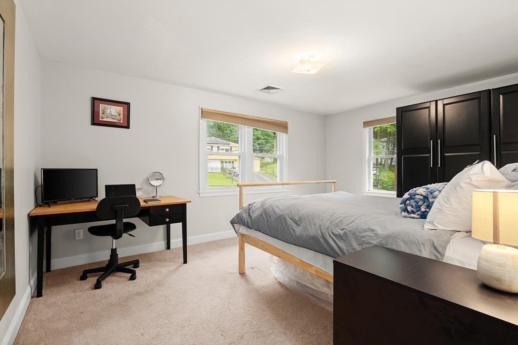 28 Highgate Road Wayland, MA 01778 - Photo 17 of 38 a bedroom with a bed a desk and chair