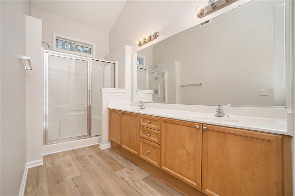 3233 Abbott Drive Southwest, Unit 7 Powder Springs, GA 30127 - Photo 17 of 24 a bathroom with a double vanity sink and mirror