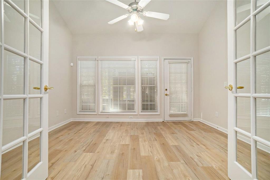 3233 Abbott Drive Southwest, Unit 7 Powder Springs, GA 30127 - Photo 21 of 24 a view of an empty room with wooden floor and a window